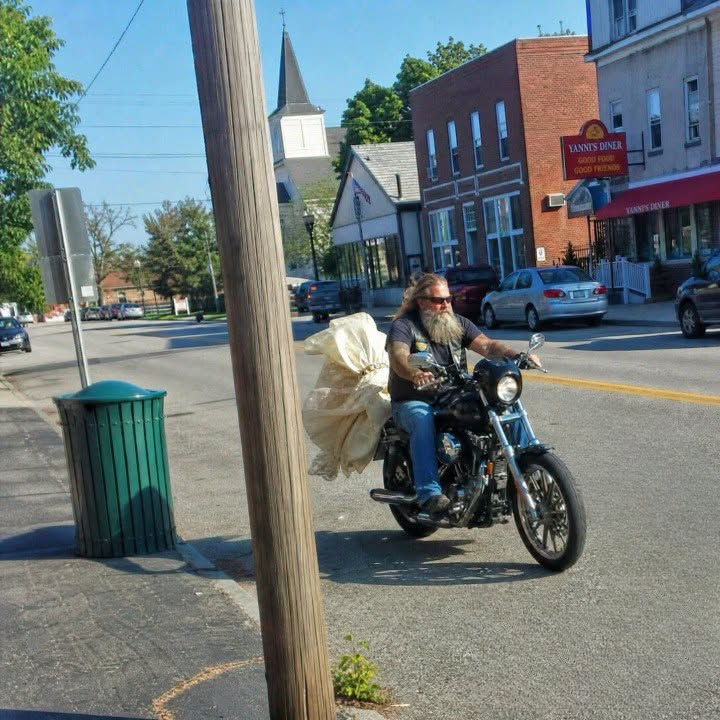 A 53-Year-Old Biker Traveled Through Town Every Day with a Weathered Wedding Dress Trailing Behind His Harley.